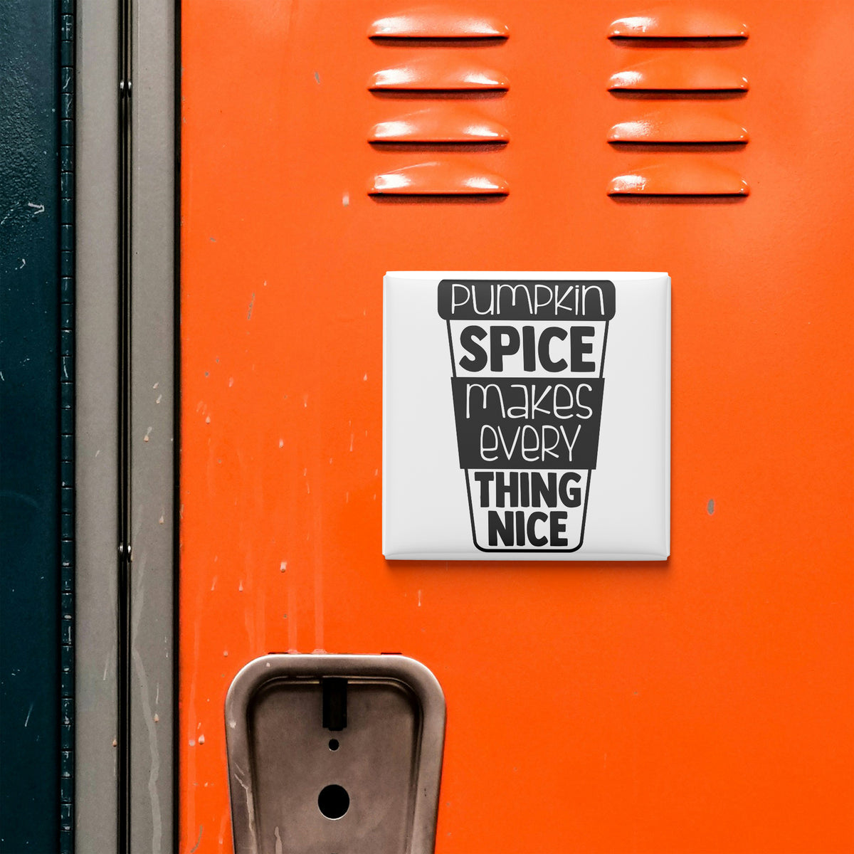 a vibrant orange surface with a white sign that reads "Pumpkin Spice Makes Everything Thing Nice" in bold black text.