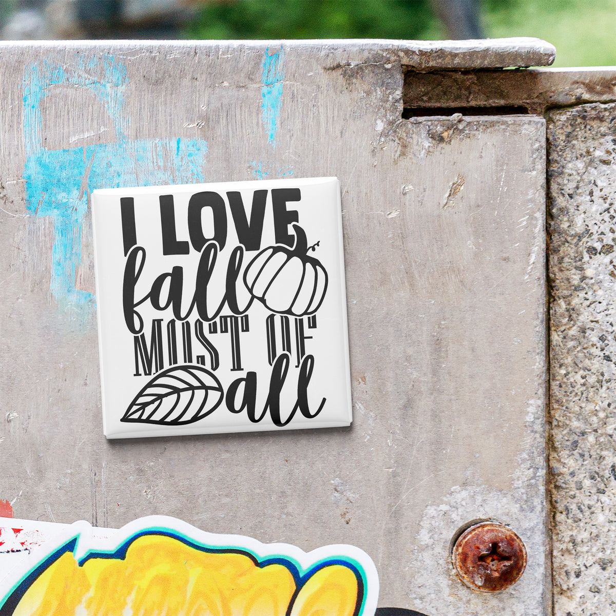 a sticker with the text "I LOVE fall MOST of all" on a concrete surface.