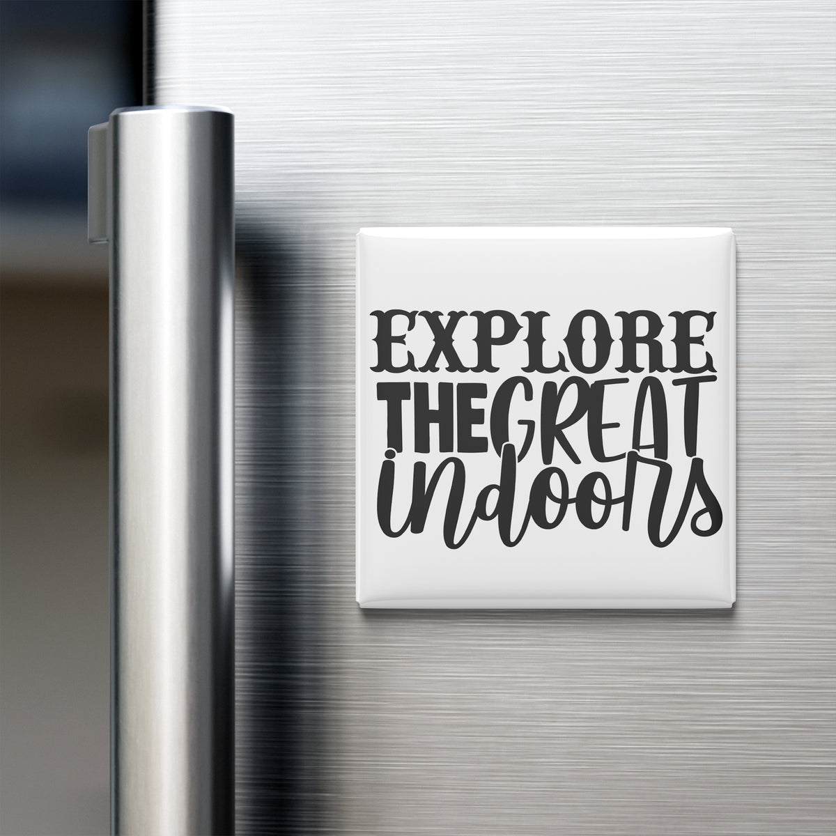 a refrigerator with a magnet that says "Explore The Great Indoors" in a stylized font.