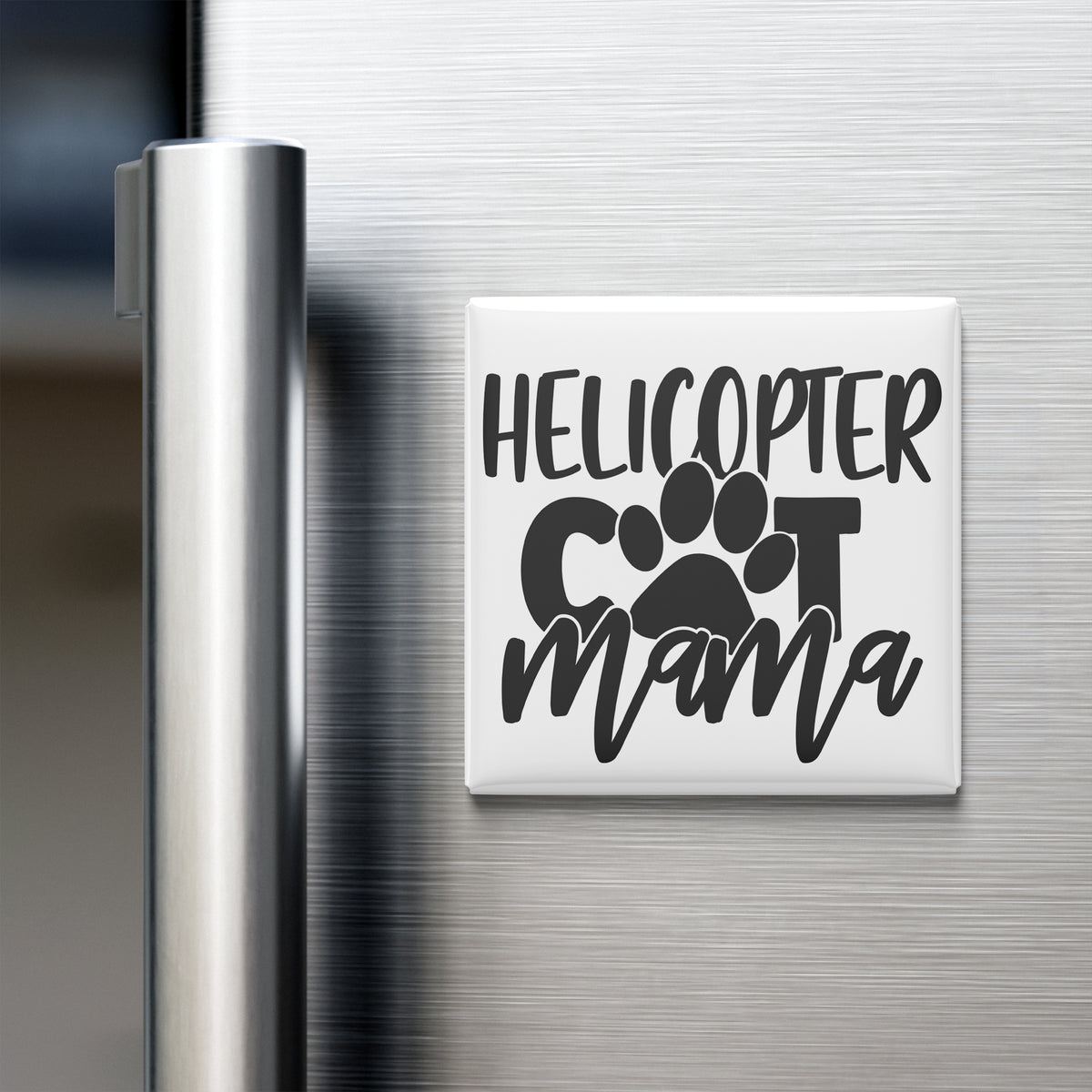 A refrigerator door with a magnet that says "HELICOPTER COT MAMA" in a stylized font.