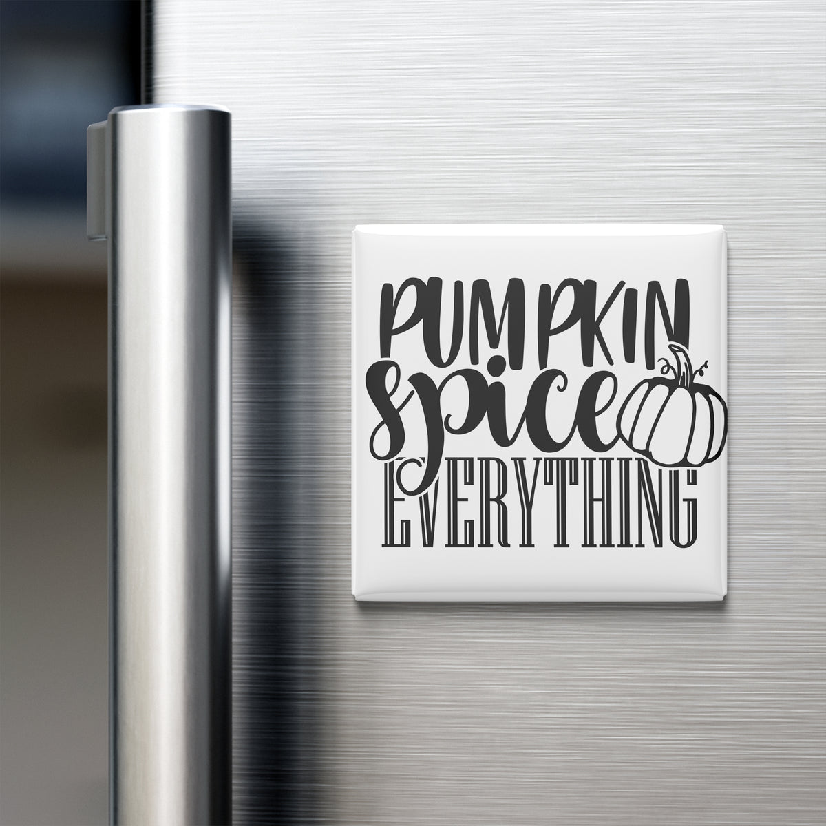 a refrigerator with a white magnet that says "Pumpkin spice everything" in black text.