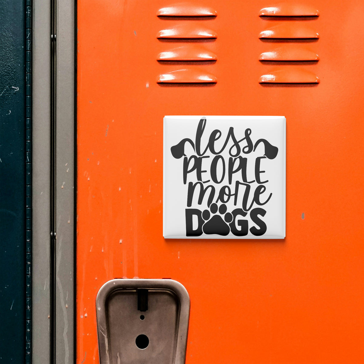 a sign with the text "less people more dogs" on an orange surface.