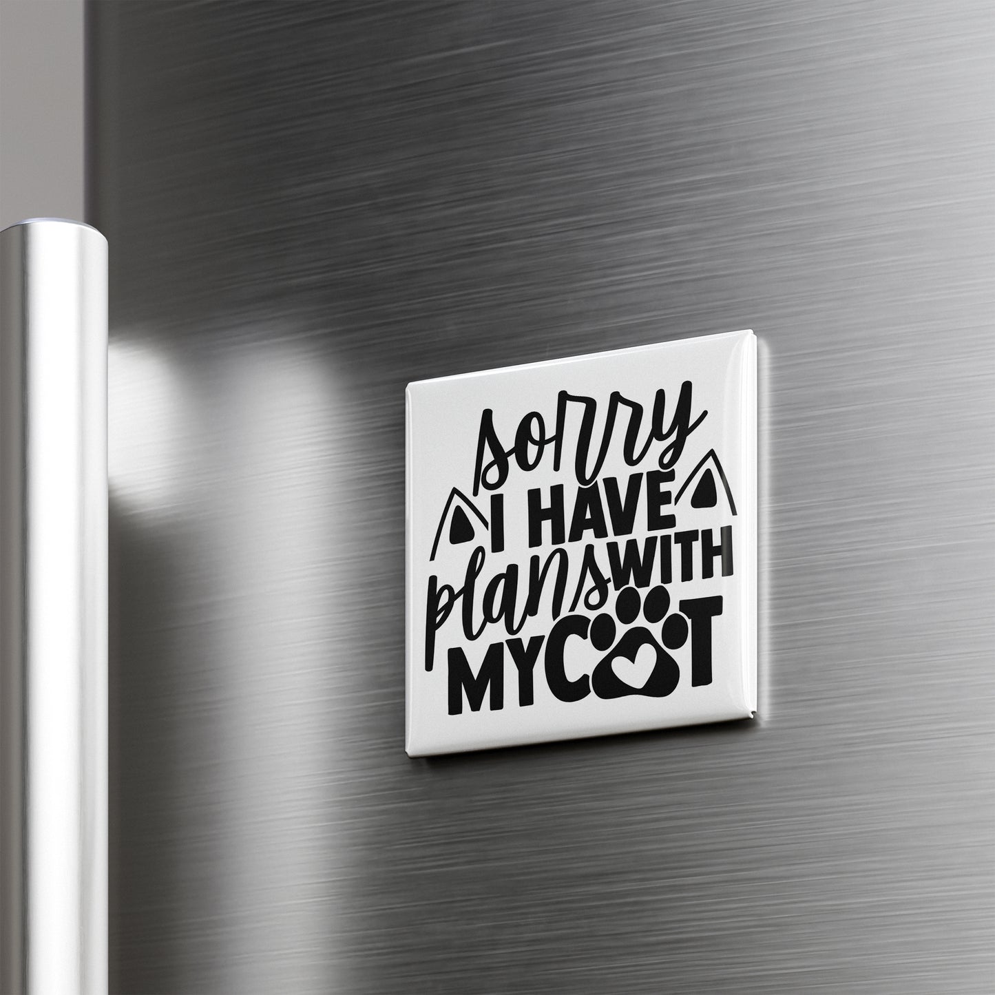 A white refrigerator magnet with the text "Sorry I have plans with my cat" printed on it.