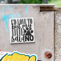 a sticker with the text "I'D LOVE TO BUT MY DOG SAID NO" on a concrete surface.
