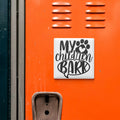 a sticker with the text "MY CHILDREN BARK" on an orange surface, which is a metal locker.