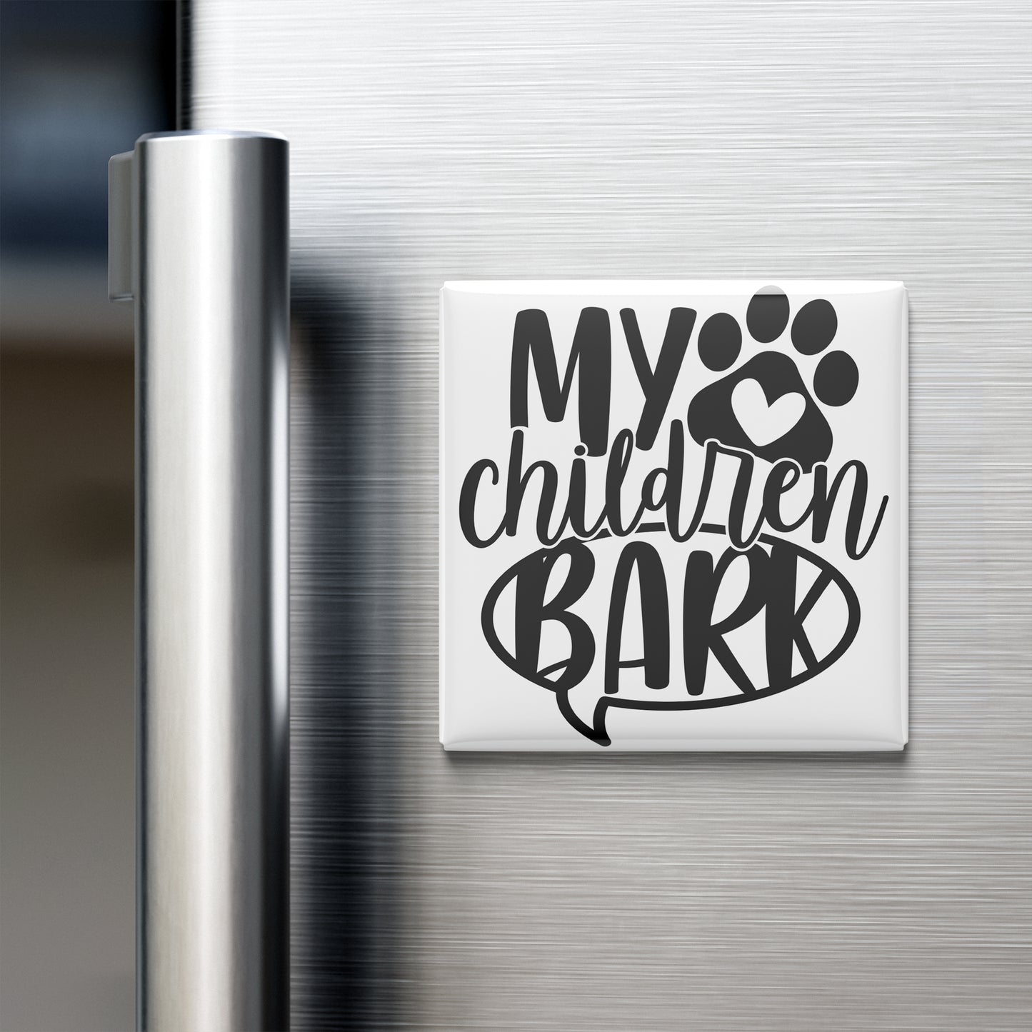 A white refrigerator magnet with the text "MY CHILDREN BARK" printed on it.