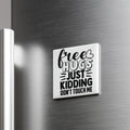 A white refrigerator door with a black and white magnet that says "Free Hugs Just Kidding Don't Touch Me".