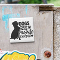 A sticker with the text "Dogs are my favorite people" is attached to a concrete surface.