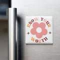 A white square magnet with a pink flower design and the text "KNOW YOUR WORTH" on it, placed on the surface of a stainless steel refrigerator.