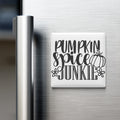 A white refrigerator magnet with the text "Pumpkin spice junk" written on it.