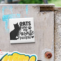 A sticker with the text "CATS are my favorite people" is attached to a concrete surface.