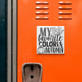 a vibrant orange locker with a sticker that reads "MY FAVORITE COLORIS AUTUMN".