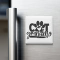 A refrigerator door with a magnet that says "COT grandmother" and features a paw print and heart symbol.