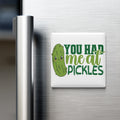 A refrigerator door with a humorous magnet that reads "YOU HAD ME AT PICKLES" in a playful font.