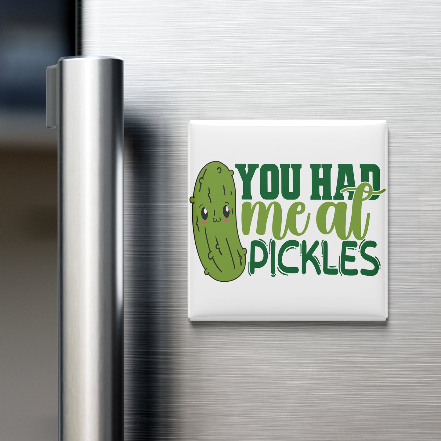 A refrigerator door with a humorous magnet that reads "YOU HAD ME AT PICKLES" in a playful font.