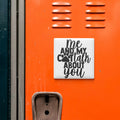 a sticker with the text "Me and my Cott talk about you" on an orange surface, which appears to be a locker or a similar storage unit.