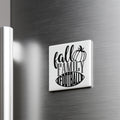 A refrigerator door with a white magnet that says "fall family football" in a stylized font.