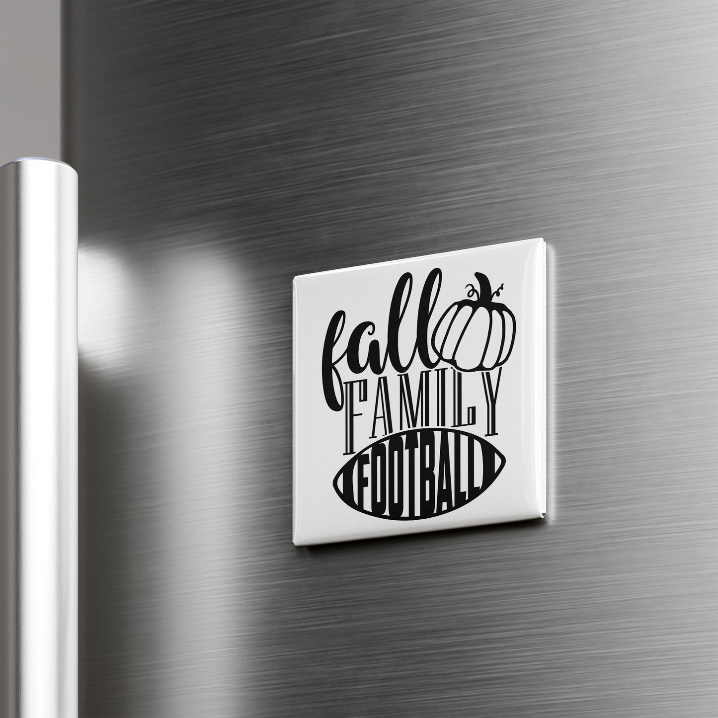 A refrigerator door with a white magnet that says "fall family football" in a stylized font.