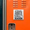 a vibrant orange wall with a black and white sign that reads "happy pumpkin spice season".