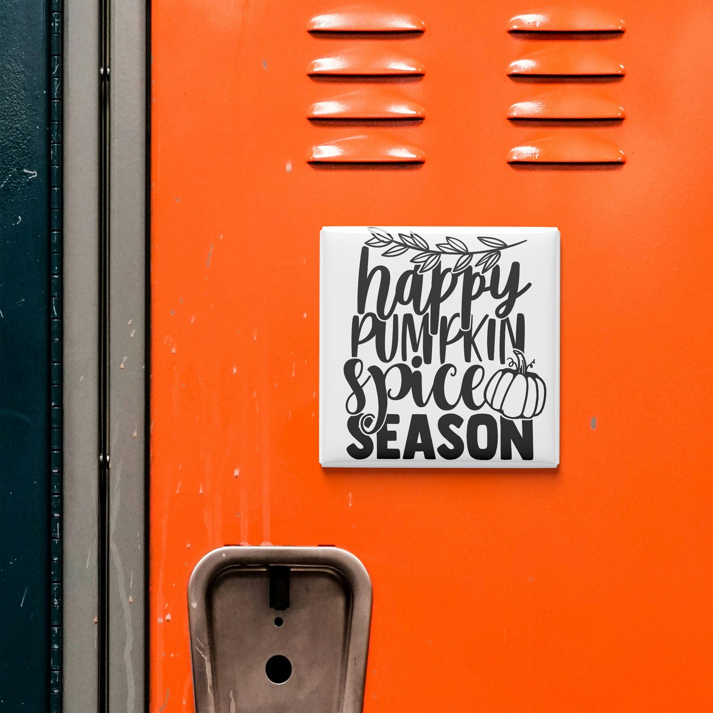a vibrant orange wall with a black and white sign that reads "happy pumpkin spice season".