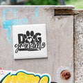 A sticker with the text "DOG grandmother" is attached to a weathered concrete surface.