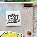 A white tile with the text "COT grandmother" is attached to a concrete wall.