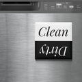 a black and white sign with the word "Clean" written on it, placed on a stainless steel surface.