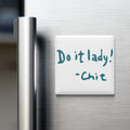 a white note attached to a metal surface, which contains the text "Do it lady! - Chit" in blue marker.