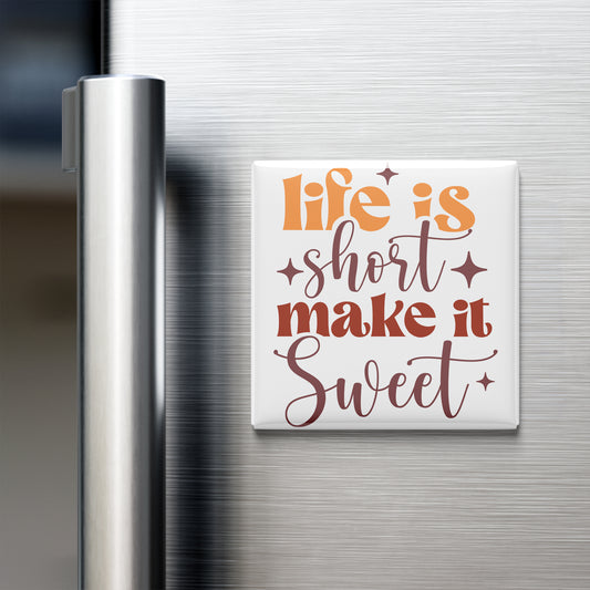 a refrigerator with a white magnet that says "Life is short, make it sweet" in a stylized font.