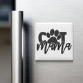 A white refrigerator magnet with the word "Cat Mama" written on it.