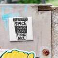 A white sticker with black text is attached to a concrete wall.