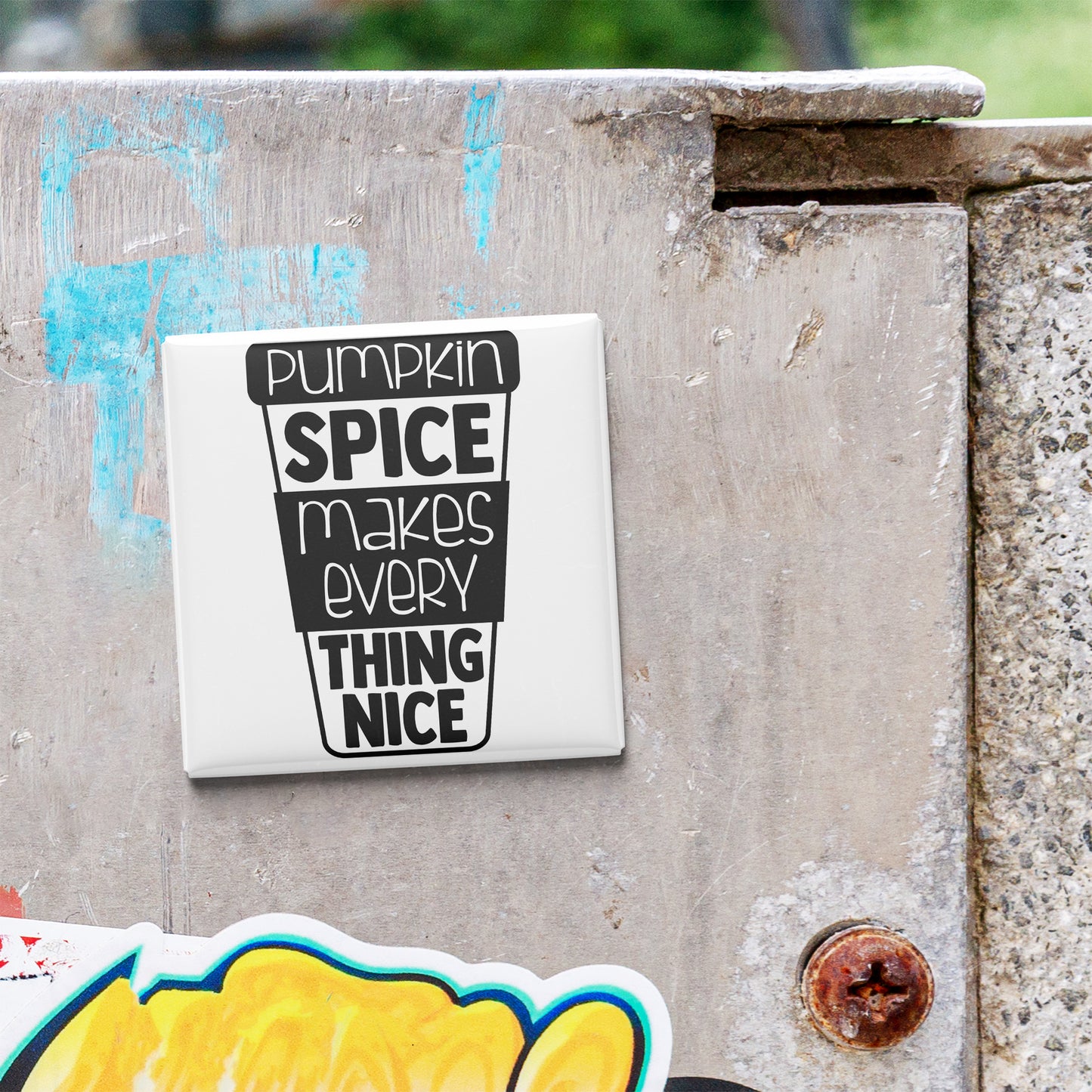 A white sticker with black text is attached to a concrete wall.