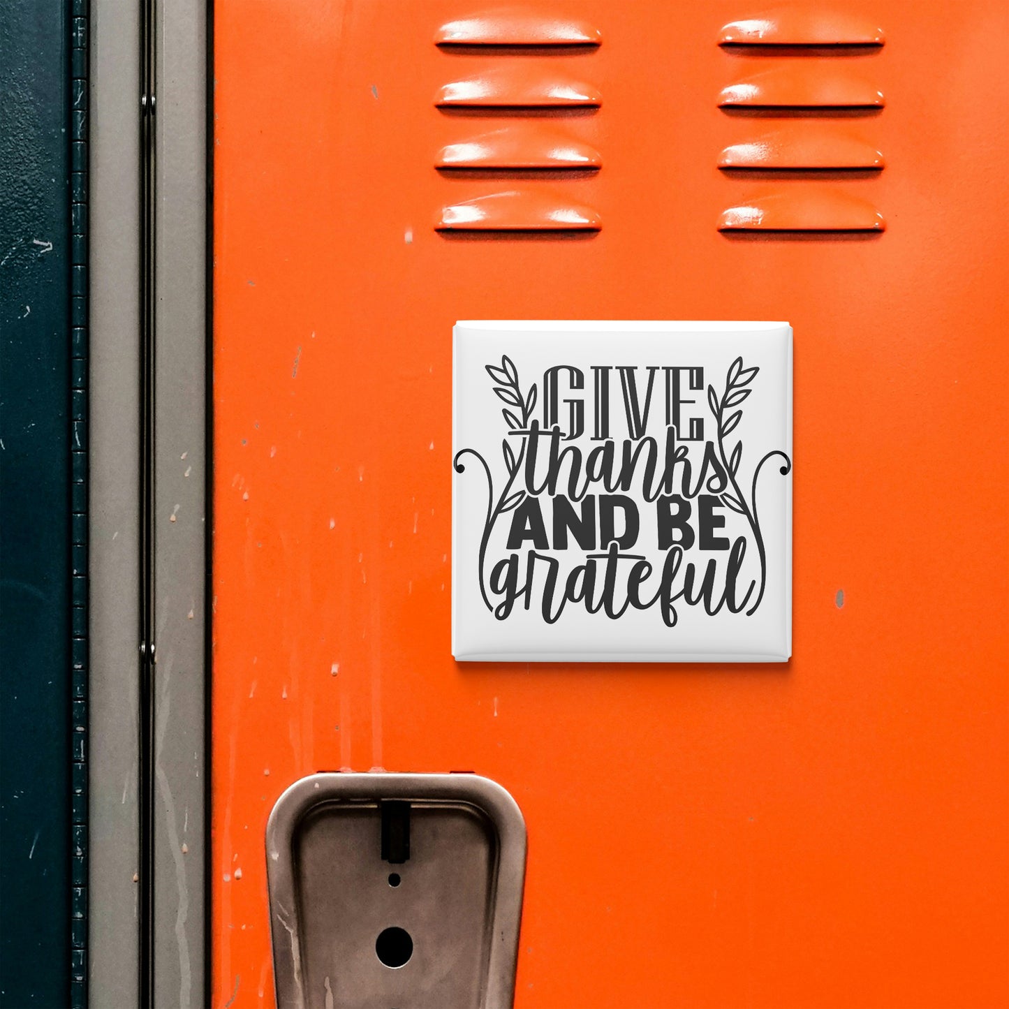 a vibrant orange wall with a white sign that reads "GIVE thanks AND BE grateful".