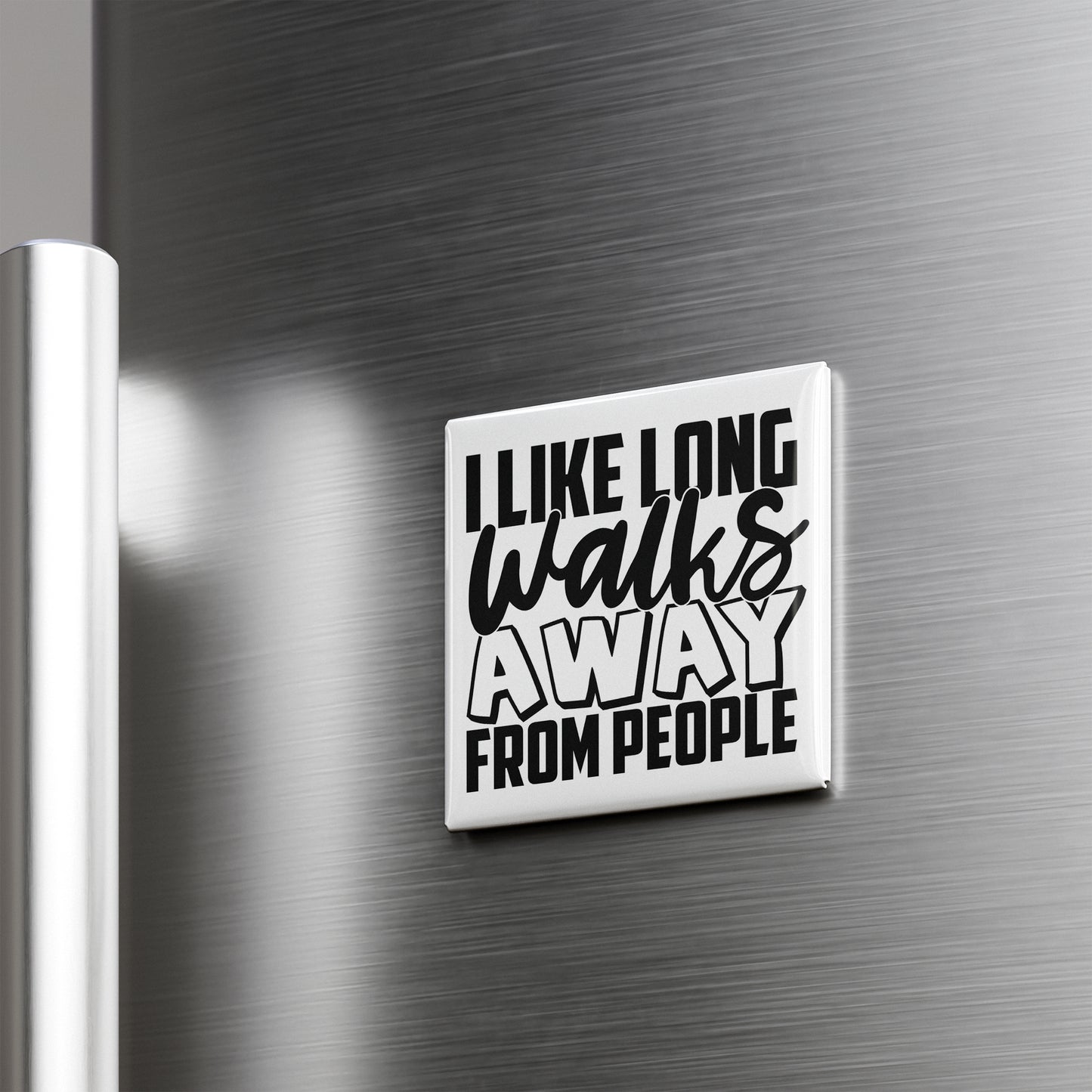 a white square magnet with the text "I LIKE LONG WALKS AWAY FROM PEOPLE" on it.