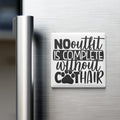 A white refrigerator magnet with the text "NO OUTFIT IS COMPLETE without COOTHAIR" printed on it.