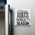 A white refrigerator magnet with the text "happy pumpkin spice season" written on it.