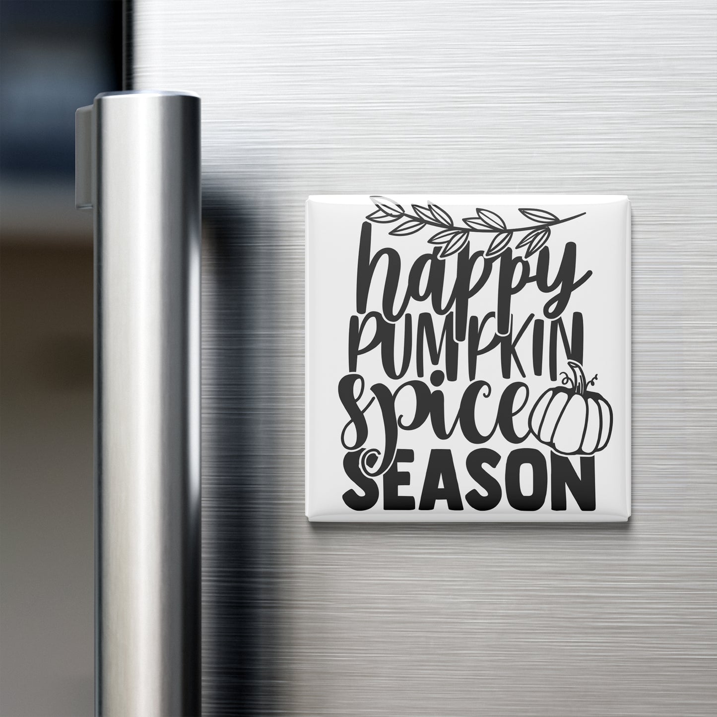 A white refrigerator magnet with the text "happy pumpkin spice season" written on it.