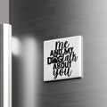 A white magnet with the text "me and my dog talk about you" on it is attached to a metallic surface.
