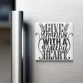 A white refrigerator magnet with the text "GIVE thanks with a grateful heart" written in a decorative font.