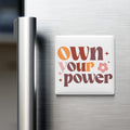 a refrigerator with a magnet that says "own your power".