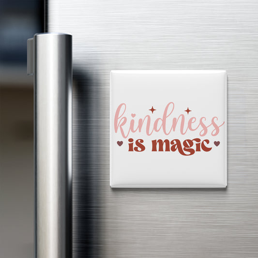 a white magnet with the text "kindness is magic" written on it, placed on a stainless steel refrigerator door.
