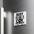 A white refrigerator magnet with the text "BUSY BEING A COT MAMA" printed on it.
