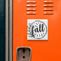 a vibrant orange locker with a white sticker that reads "fall" and a decorative leaf design.