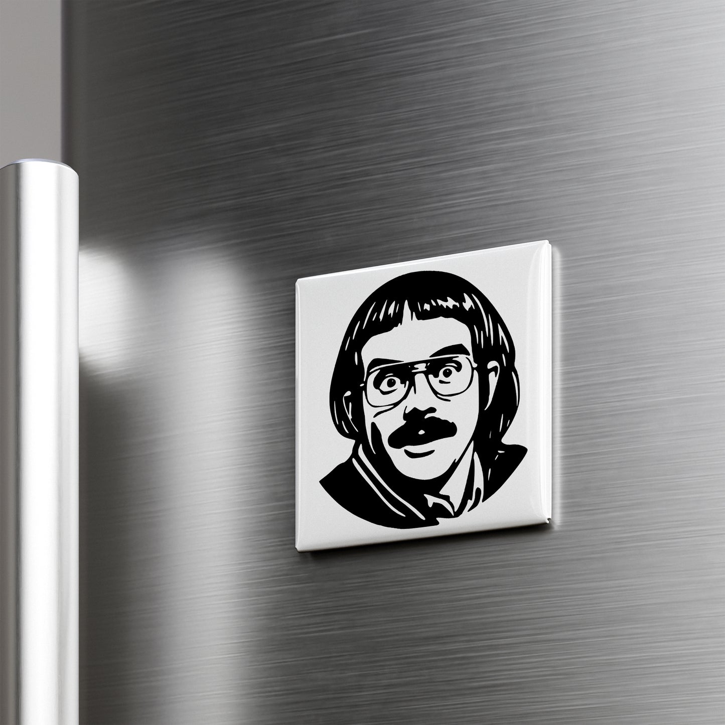 A black and white image of a man's face with glasses and a mustache is displayed on a metallic surface.