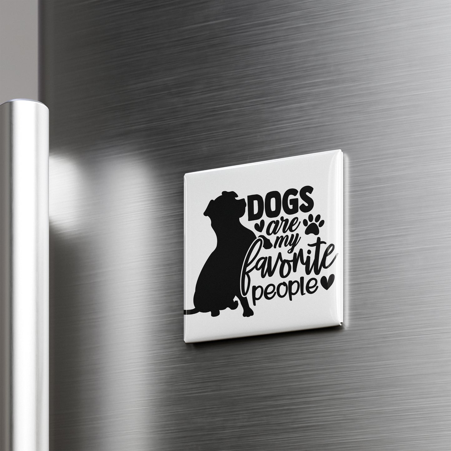 A magnet with the text "Dogs are my favorite people" on it, featuring a silhouette of a dog.