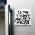 A refrigerator door with a magnet that says "Sorry I Have Plans With My Cat" in a stylized font.
