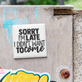 a sticker with the text "Sorry I'm Late I Didn't Want to Come" on a metal surface.