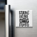 A white refrigerator magnet with the text "STAY AT HOME DOG MOM" printed on it.