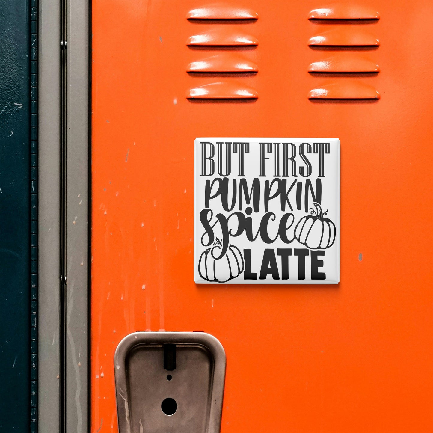 a vibrant orange wall with a white sign that reads "BUT FIRST PUMPKIN SPICE LATTE" in bold black letters.