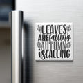 A white refrigerator magnet with the text "LEAVES ARE FALLING AUTUMN IS CALLING" printed on it.